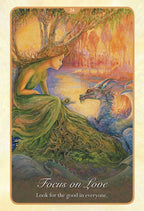 Tarot card with a woman and dragon by a lake, featuring the text 'Focus on Love. Look for the good in everyone.'