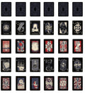 A set of illustrated playing cards arranged in a grid on a plain white background. The cards feature dark, gothic, and occult-style artwork with black, red, cream, and gray tones, including symbols, faces, and abstract designs.