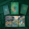 Collection of tarot cards with intricate designs on a dark green fabric background