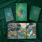 Collection of tarot cards with intricate designs on a dark green fabric background