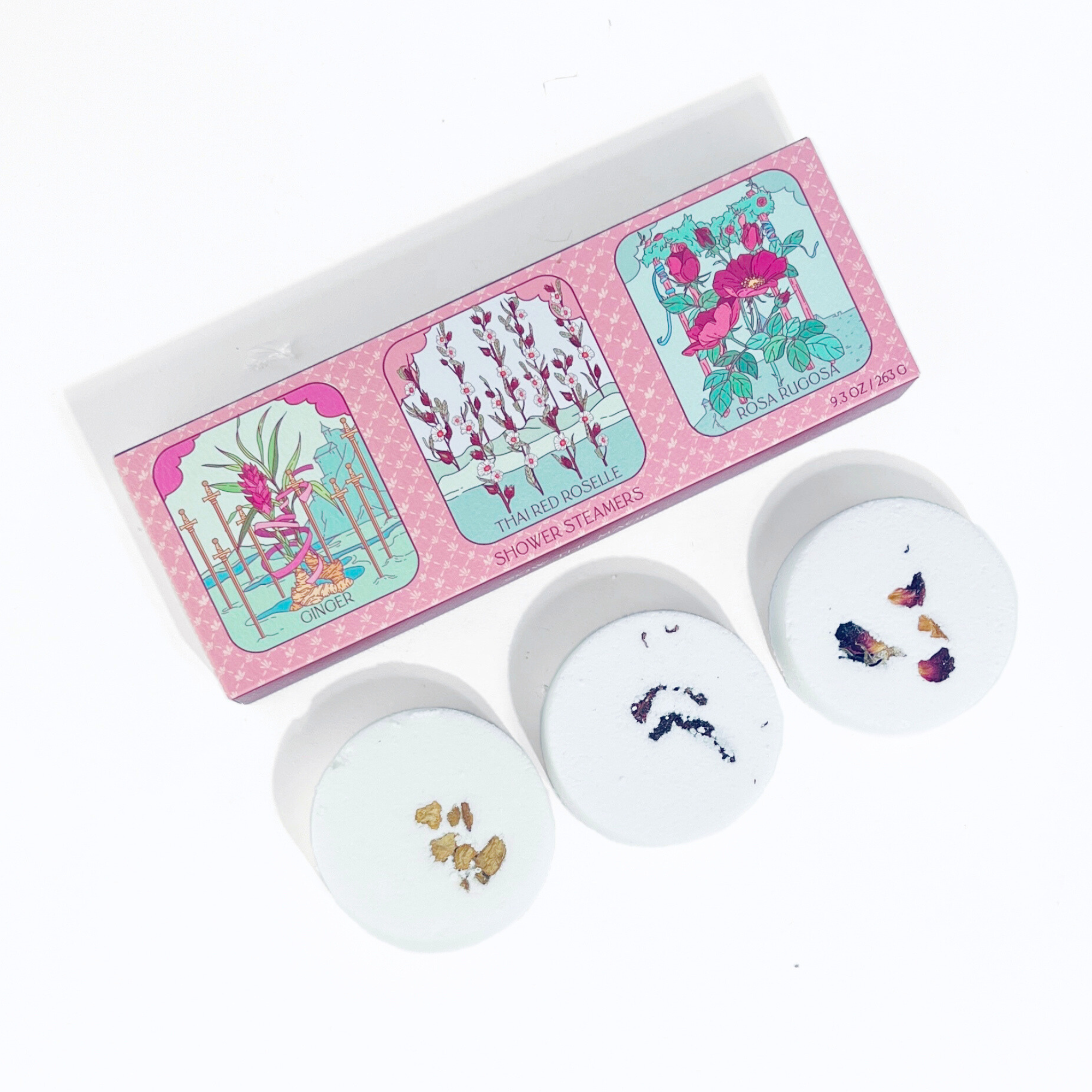 Set of four stampers with floral designs in a pink box on a white background