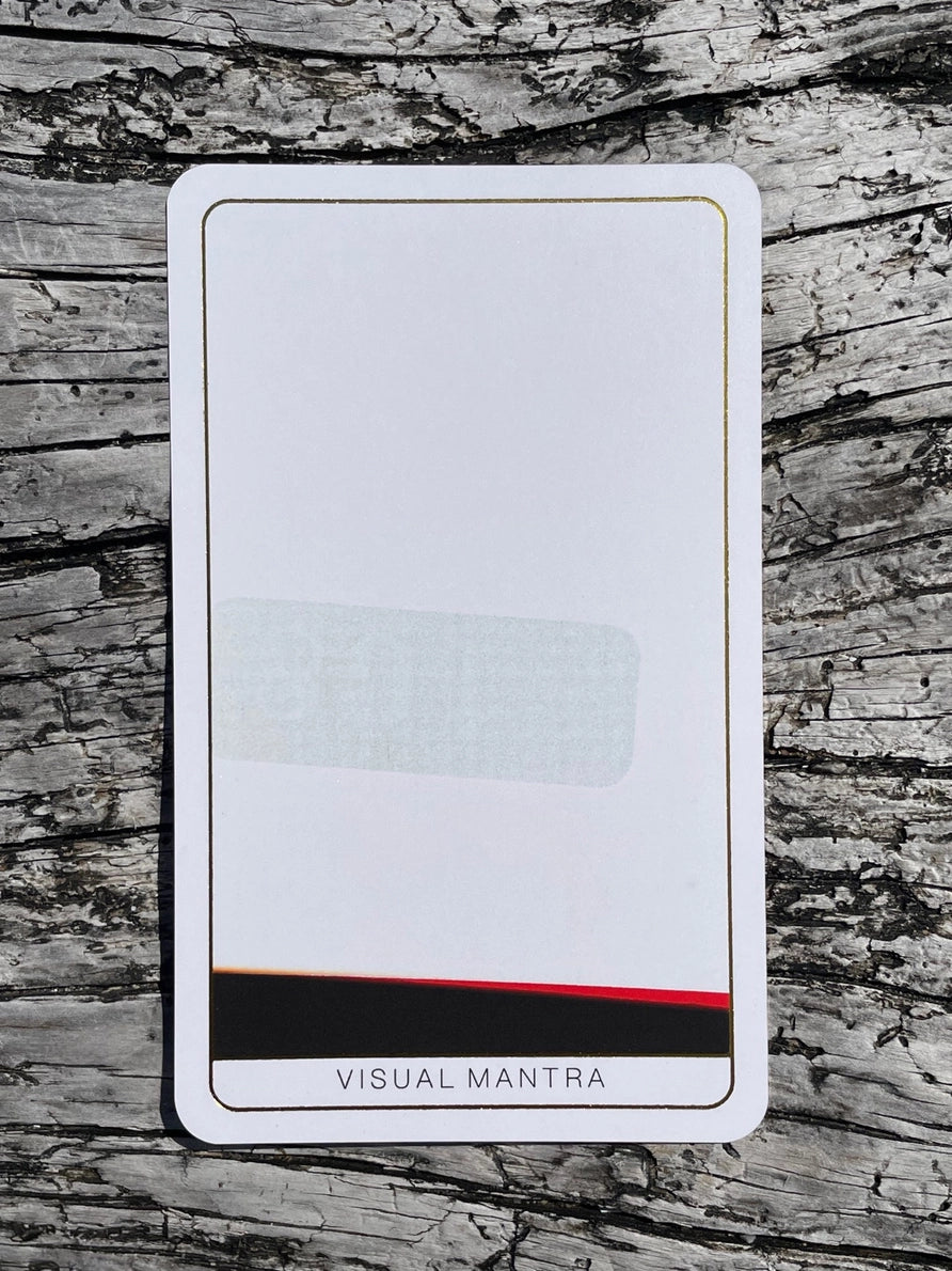 Card with 'Visual Mantra' branding on a wooden surface