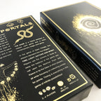 Two black game boxes with gold foil detailing, shown at an angle on a white background. The front box displays the title 'PORTALS' and game description text, while the side box shows a glowing spiral emblem.