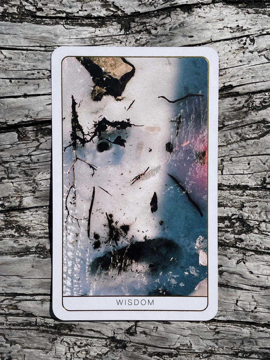 Card with abstract design and 'Wisdom' text on a textured surface