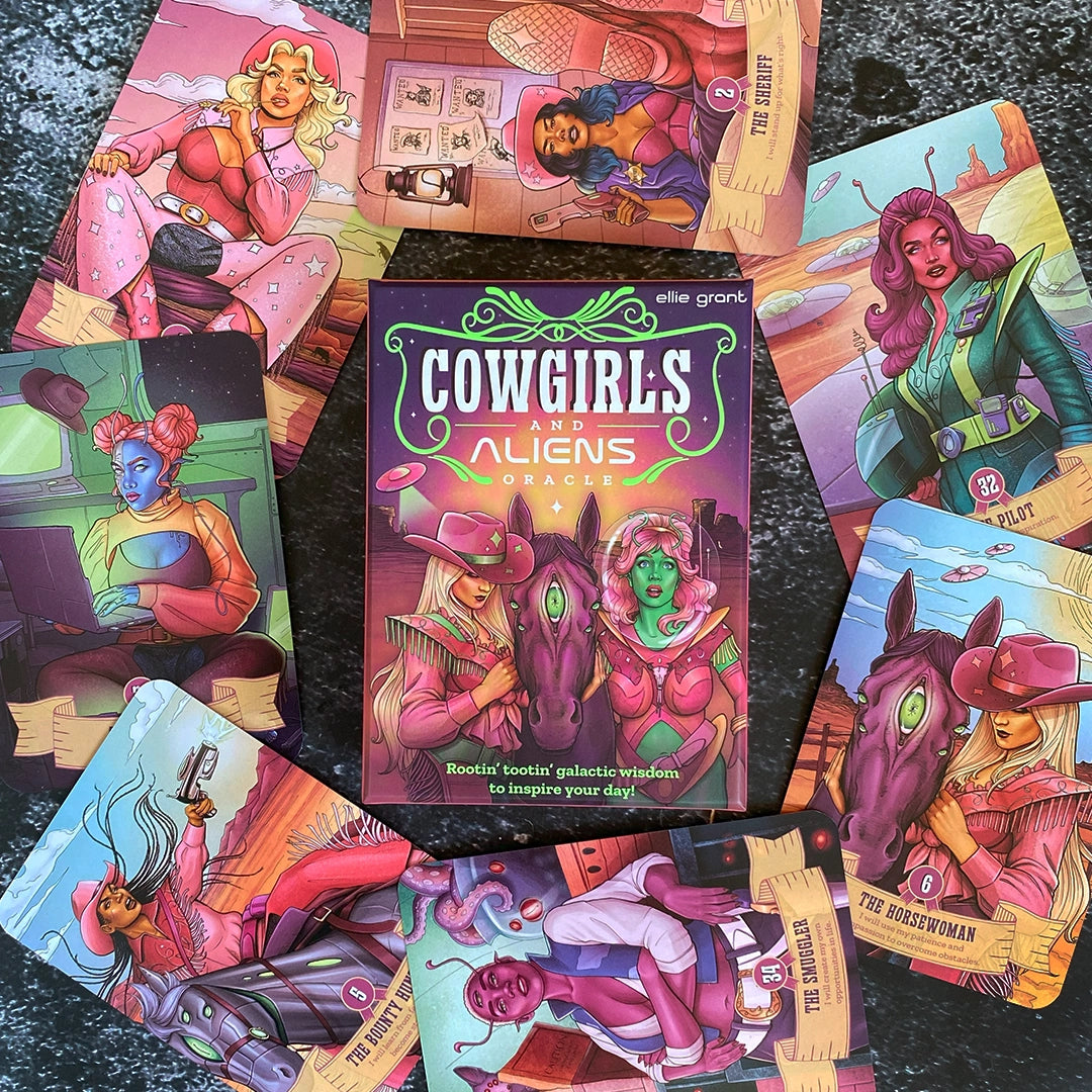 Collection of colorful card designs featuring cowgirls and aliens with a central 'Cowgirls and Aliens' book.