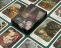 Garden of Chocolates box surrounded by illustrated cards on a green surface