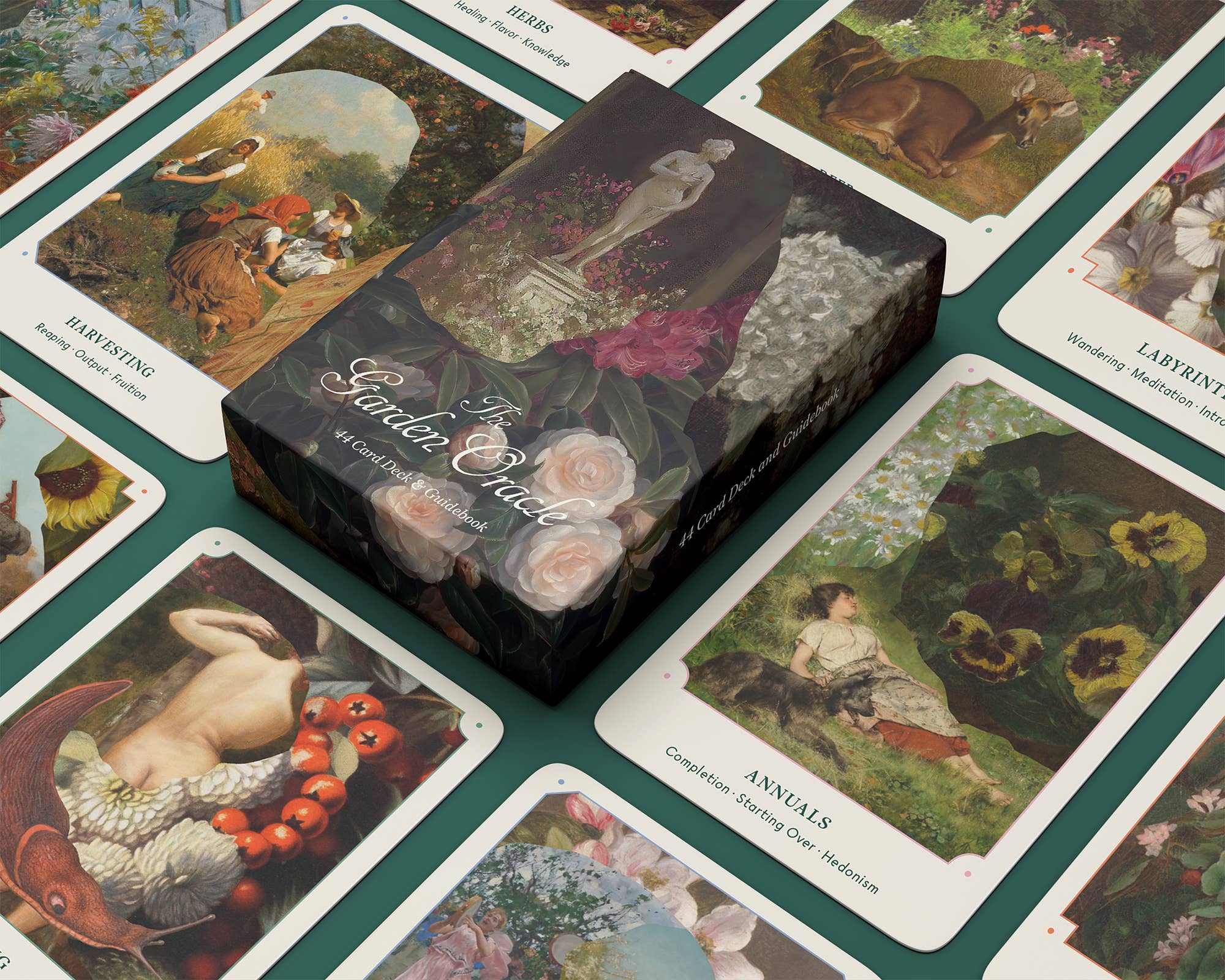 Garden of Chocolates box surrounded by illustrated cards on a green surface