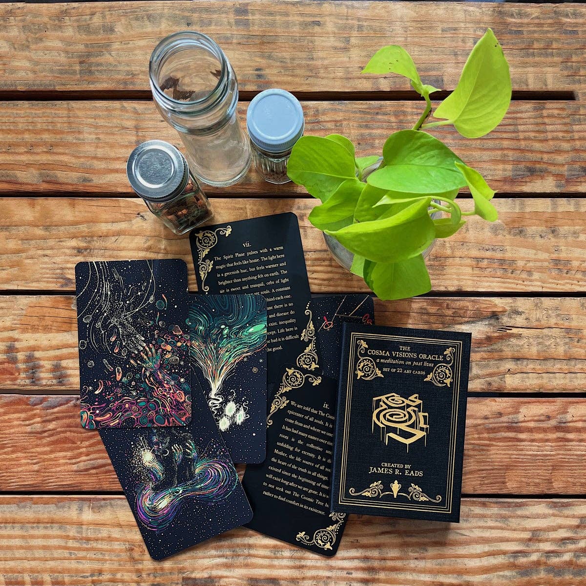 Ornate cards and a plant on a wooden surface