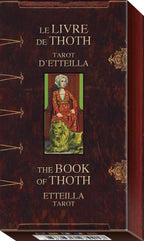 Tarot deck box with 'Le Livre de Thoth' and 'The Book of Thoth' text, featuring a tarot card illustration on a dark brown background.
