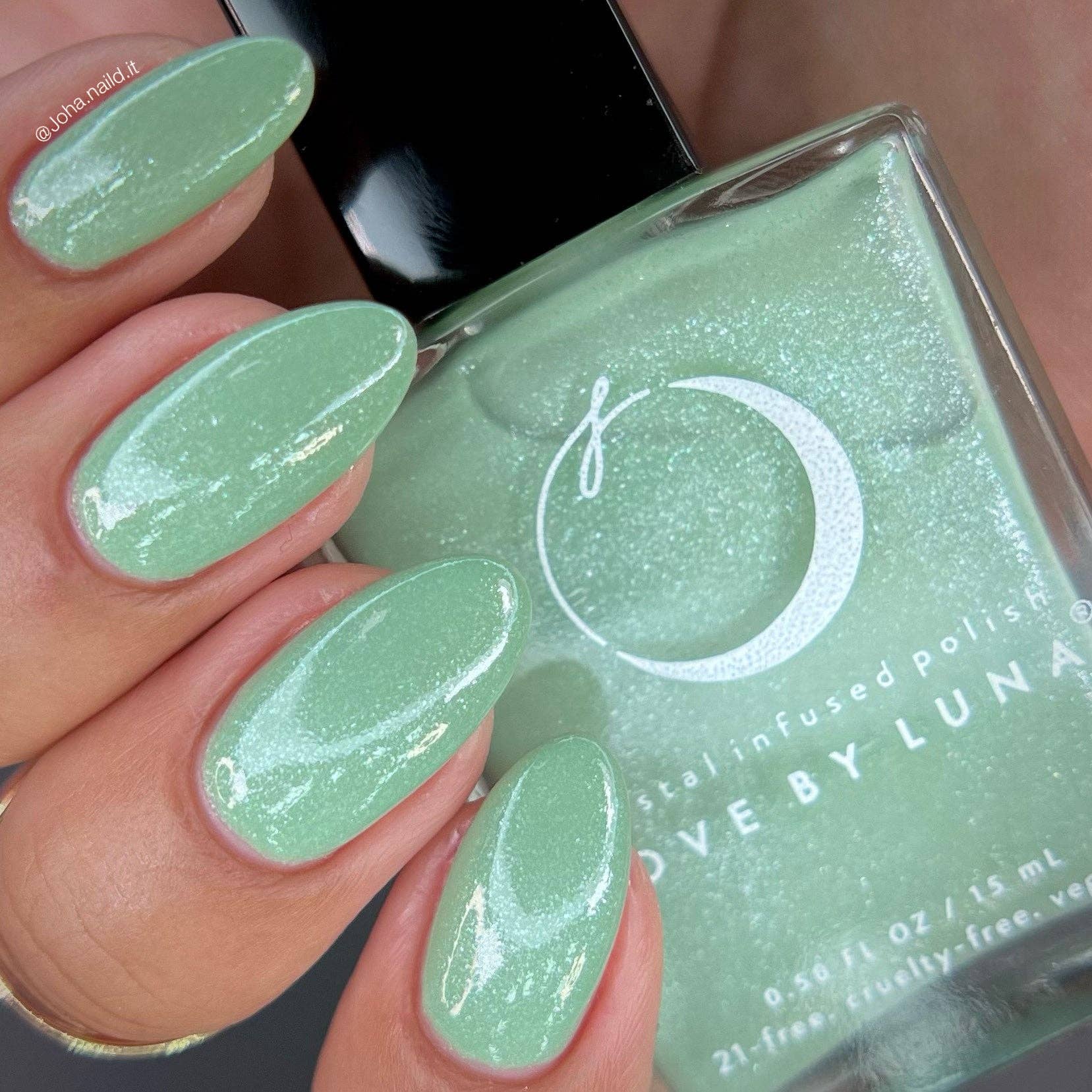 Green nail polish with a hand displaying matching nails and 'Love by Luna' branding.