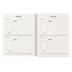 Open spiral-bound planner with grid and note-taking layout on white background