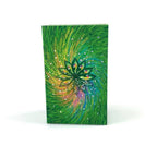 Notebook with a colorful design of a lotus flower on a green background