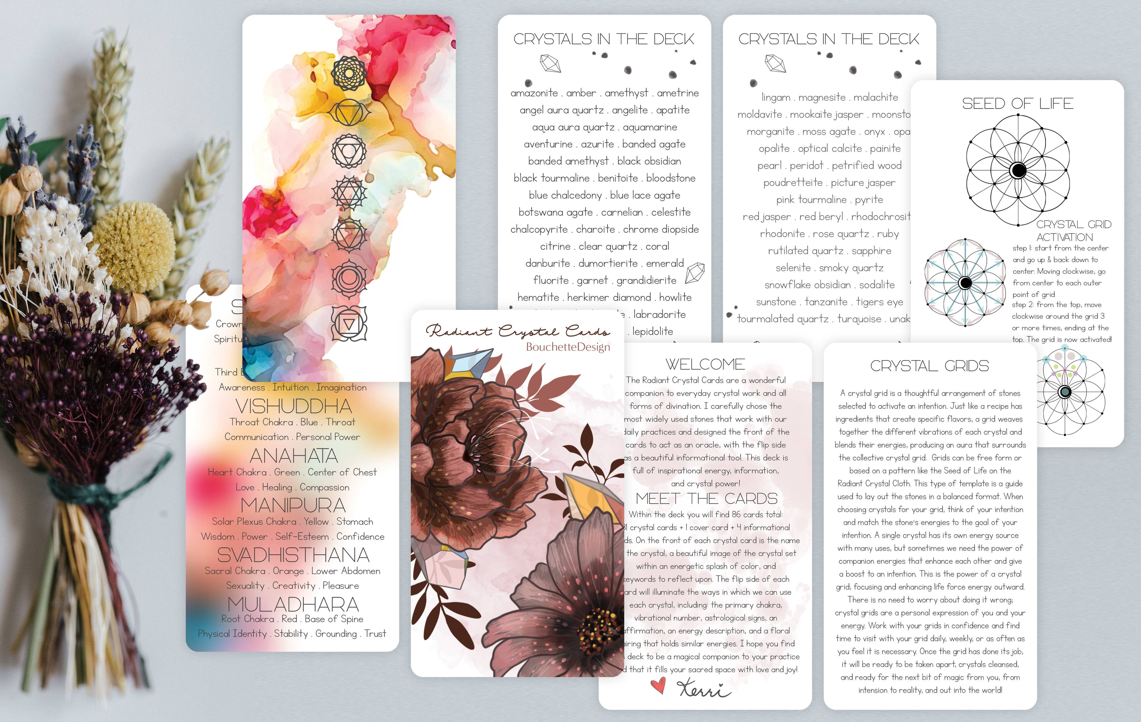 A set of printed crystal card decks and guide cards arranged on a white surface with dried flowers beside them. The cards feature watercolor floral designs, geometric crystal grids, and text sections titled 'Crystals in the Deep,' 'Seed of Life,' and 'Religious Crystal Cards.