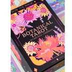 Botanical Tarot card deck with colorful floral designs on a black background