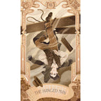 Tarot card titled 'The Hanged Man' with decorative border and intricate details.