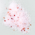 Pink bath salts with red flowers on a light gray background