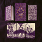Set of purple and white tarot cards with intricate designs on a dark background