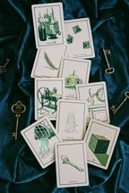 Set of tarot cards with illustrations on a dark blue fabric background