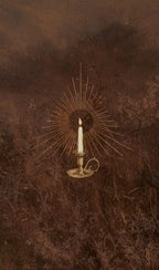 Decorative wall art with a candle and sunburst design on a textured brown background