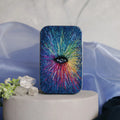 Colorful abstract design phone case on a white pedestal with decorative elements