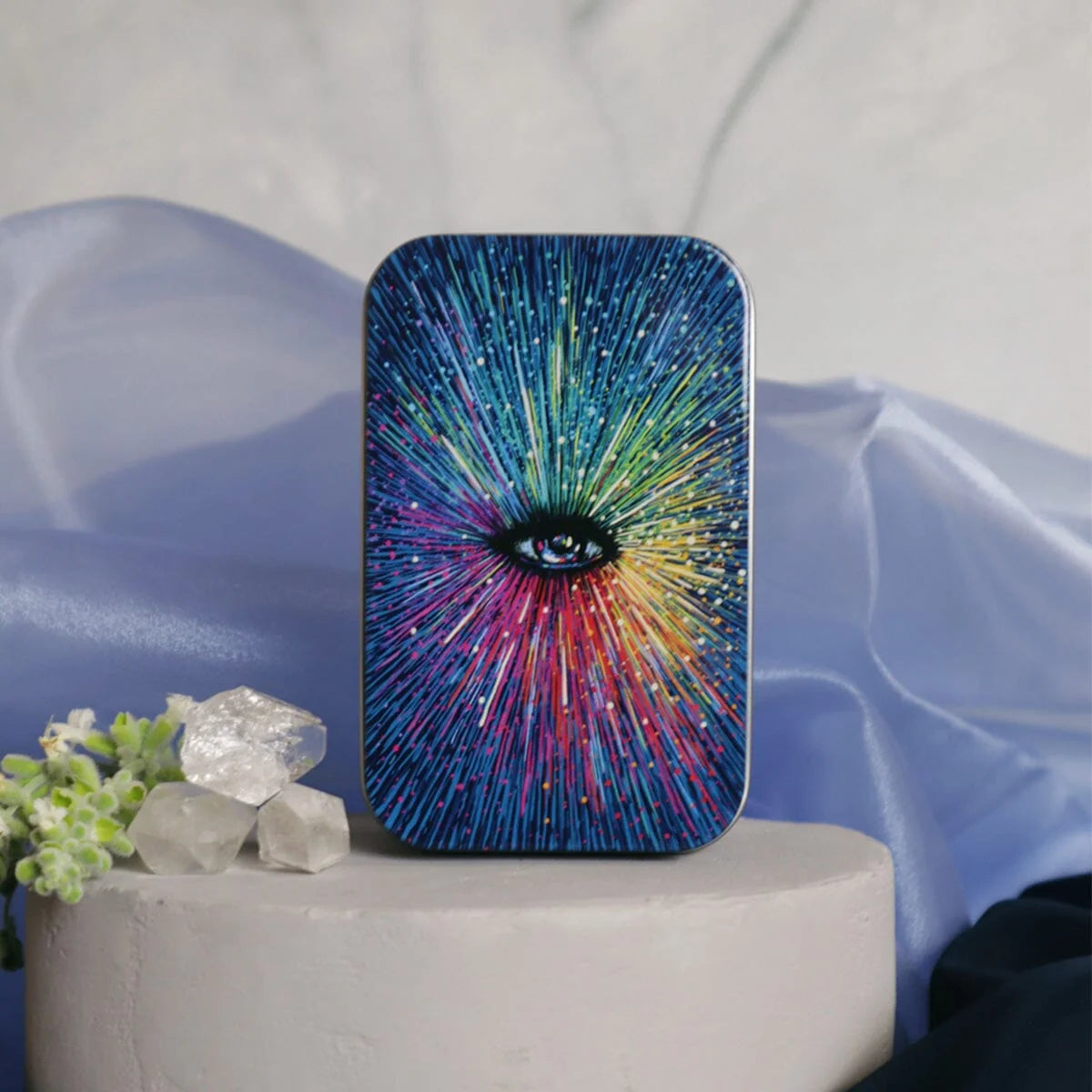 Colorful abstract design phone case on a white pedestal with decorative elements