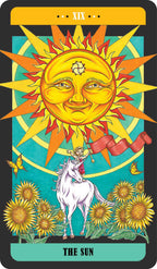 Tarot card featuring a sun with a face, a unicorn, and flowers on a blue background.