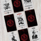 Collection of tarot cards with various designs and symbols on a wooden surface