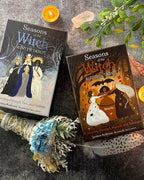 Two tarot books titled 'Seasons of the Witch' on a dark surface with decorative elements.