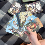 Collection of tarot cards with fantasy designs on a checkered fabric background